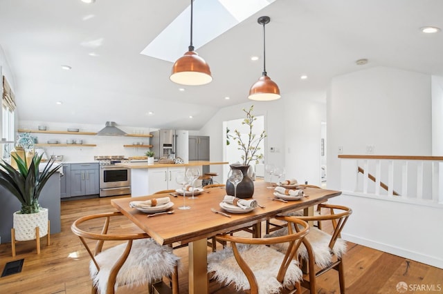 dining space featuring lofted ceiling, light wood-style flooring, recessed lighting, and visible vents