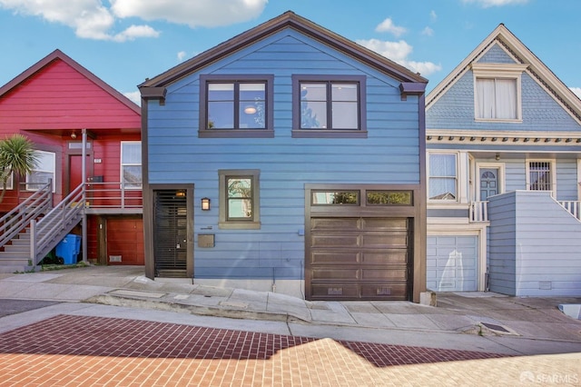 view of front of home featuring stairway, decorative driveway, and a garage