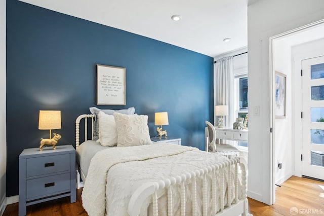 bedroom featuring recessed lighting, wood finished floors, and baseboards