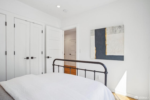 bedroom with recessed lighting and light wood-style flooring