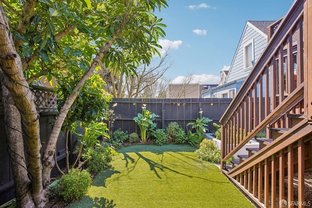 view of yard featuring stairway and a fenced backyard