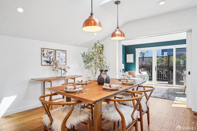 dining space with light wood finished floors, recessed lighting, baseboards, and vaulted ceiling