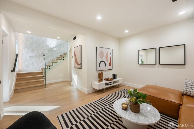1935 Greenwich St, San Francisco, CA 94123 - living area featuring light wood finished floors, baseboards, visible vents, stairway, and recessed lighting