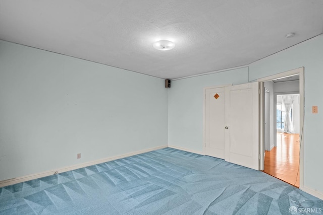 interior space featuring carpet floors and a textured ceiling