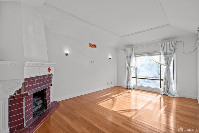 unfurnished living room with hardwood / wood-style floors and a fireplace