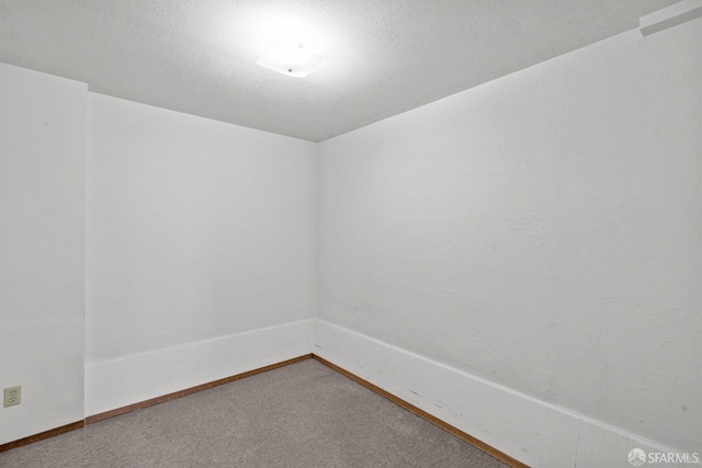 spare room with carpet floors and a textured ceiling