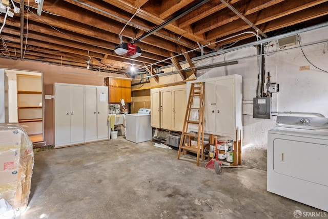 garage featuring a garage door opener, washer / clothes dryer, and electric panel