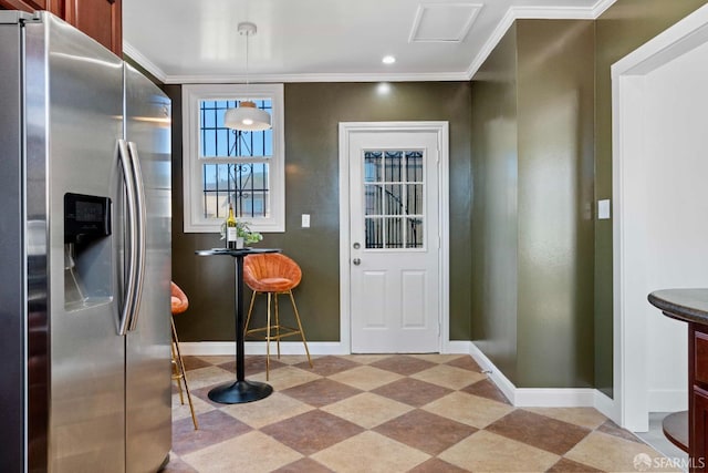 interior space featuring light floors, baseboards, stainless steel refrigerator with ice dispenser, and ornamental molding