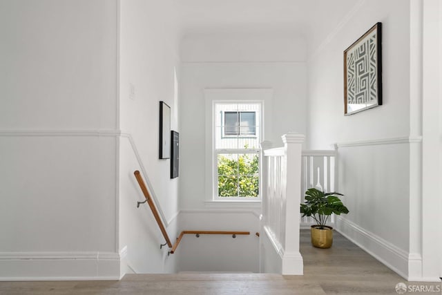 stairway featuring baseboards and wood finished floors