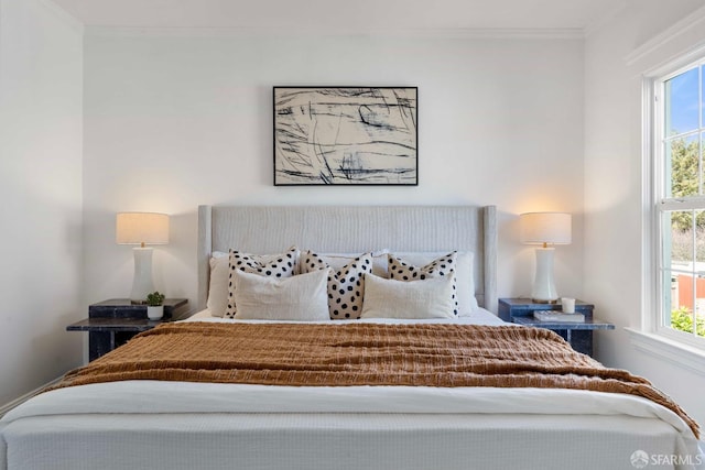 bedroom featuring multiple windows and ornamental molding