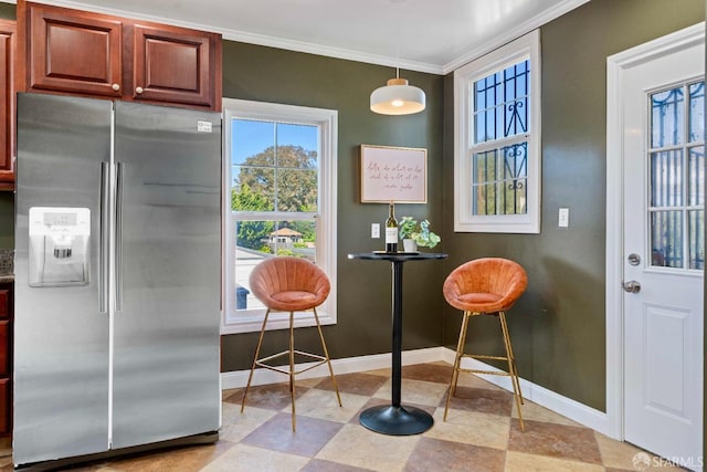 interior space with baseboards and ornamental molding