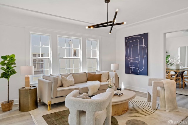 living room featuring wood finished floors, baseboards, and a chandelier