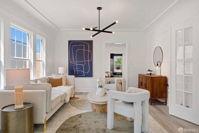 living area featuring light wood-type flooring and a chandelier