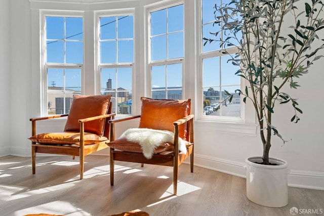 sitting room with wood finished floors and baseboards