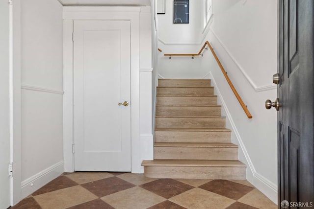 staircase featuring tile patterned floors