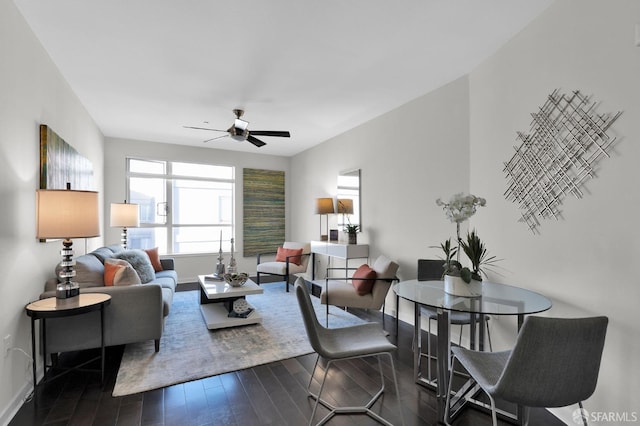 living room with dark wood-type flooring and ceiling fan