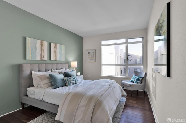 bedroom with dark hardwood / wood-style floors