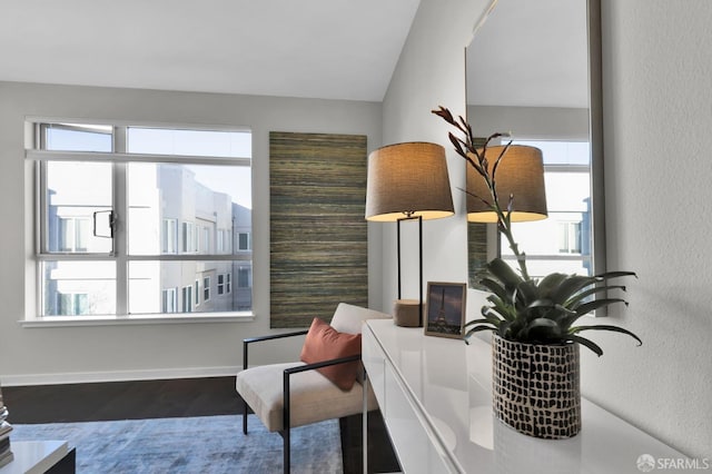 sitting room with dark hardwood / wood-style floors and lofted ceiling