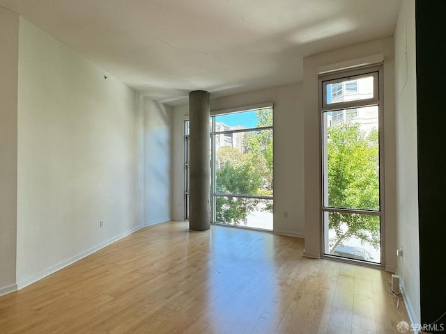 unfurnished room with light hardwood / wood-style flooring