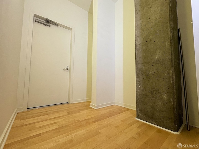 hallway with light hardwood / wood-style floors