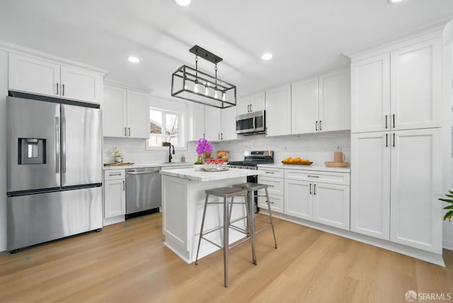 3901 La Colina Rd, El Sobrante, CA 94803 - kitchen with stainless steel appliances, a sink, white cabinets, light wood-style flooring, and recessed lighting