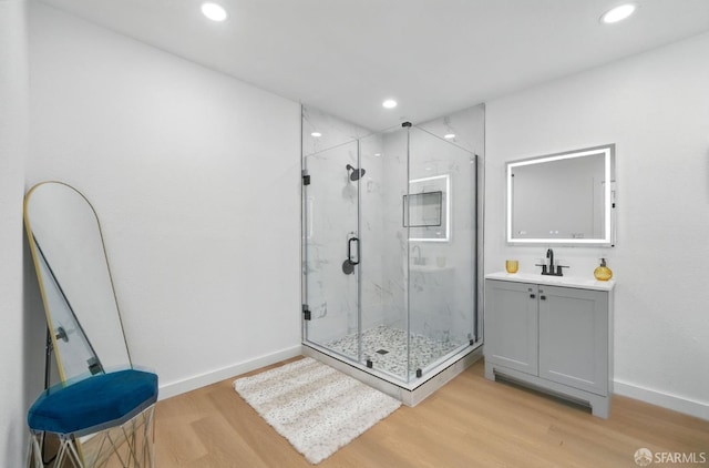 3901 La Colina Rd, El Sobrante, CA 94803 - bathroom with wood finished floors, a marble finish shower, vanity, baseboards, and recessed lighting