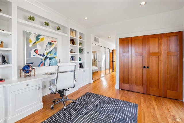 office area featuring recessed lighting, visible vents, built in features, built in study area, and light wood finished floors