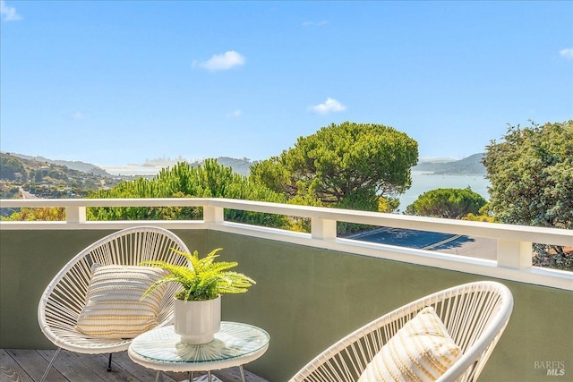 balcony with a water and mountain view