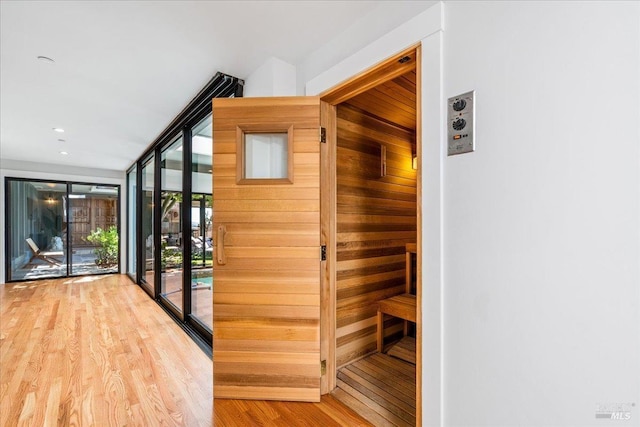 interior space with floor to ceiling windows and wood finished floors