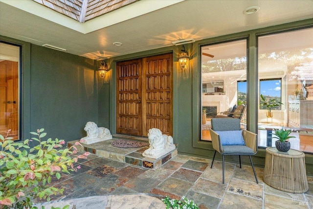 property entrance featuring mansard roof