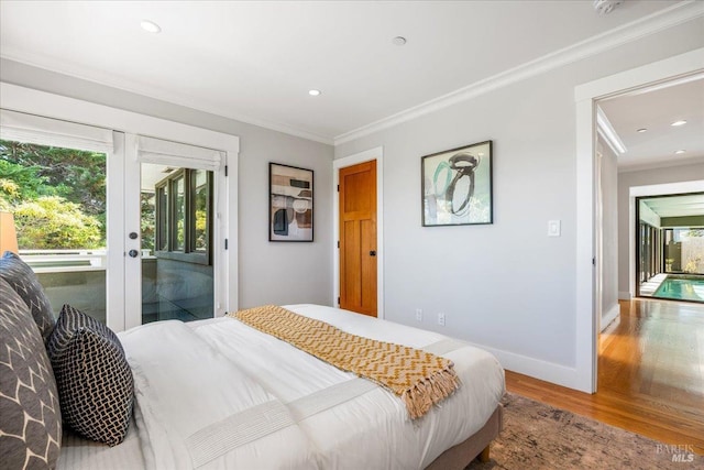 bedroom with baseboards, ornamental molding, wood finished floors, access to exterior, and french doors