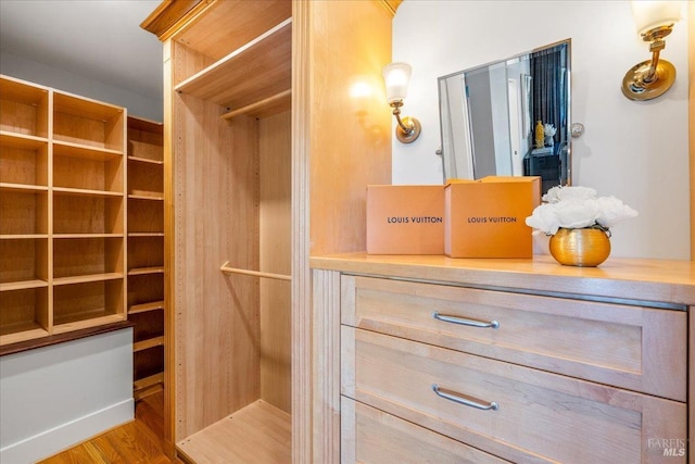 walk in closet featuring wood finished floors