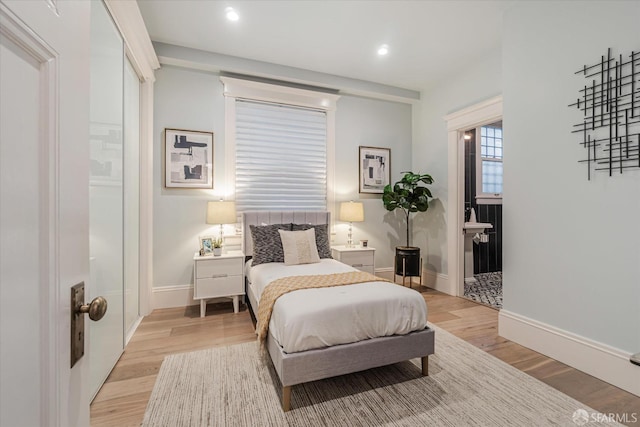 bedroom with recessed lighting, baseboards, and light wood-type flooring