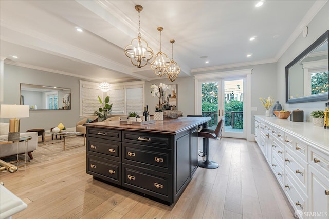 spacious closet with an inviting chandelier and light wood-style flooring