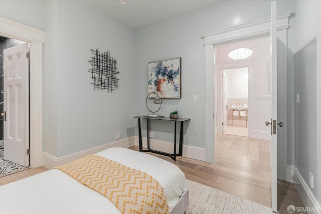 bedroom with baseboards and wood finished floors