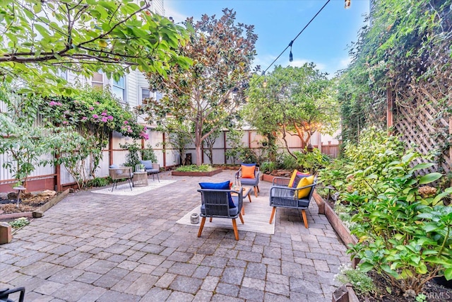 view of patio / terrace with an outdoor living space and a fenced backyard