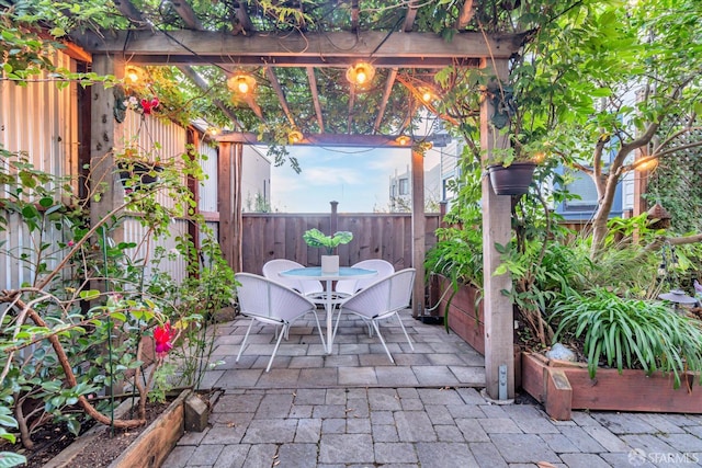 view of patio / terrace featuring a pergola, fence, and outdoor dining space