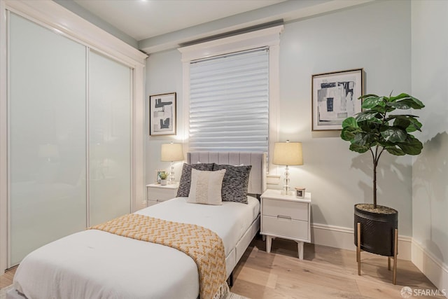 bedroom featuring light wood-style flooring and a closet
