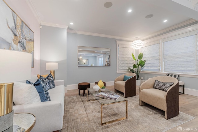 living area with baseboards, ornamental molding, and wood finished floors
