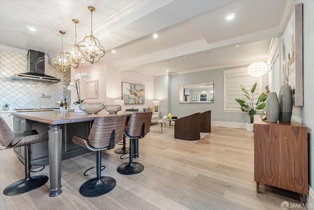 dining space featuring crown molding, baseboards, a chandelier, recessed lighting, and light wood-style flooring