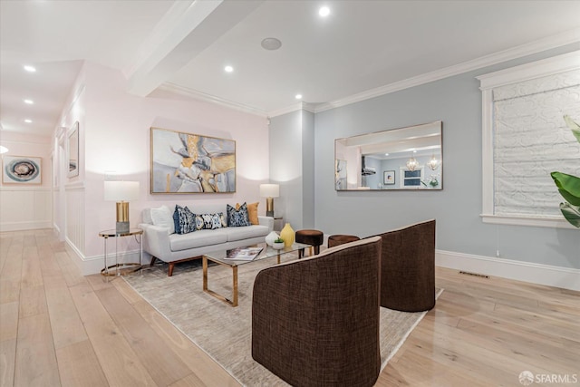living room featuring recessed lighting, ornamental molding, baseboards, and wood finished floors