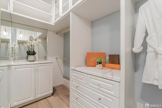 walk in closet featuring light wood-style floors