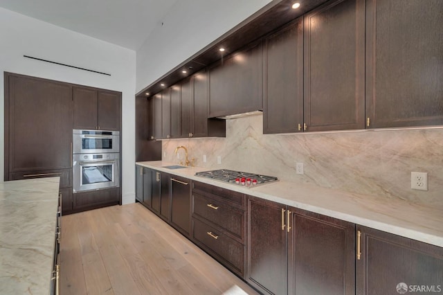 288 Pacific Ave Unit 4E, San Francisco, CA 94111 - kitchen with stainless steel appliances, dark brown cabinetry, a sink, and tasteful backsplash