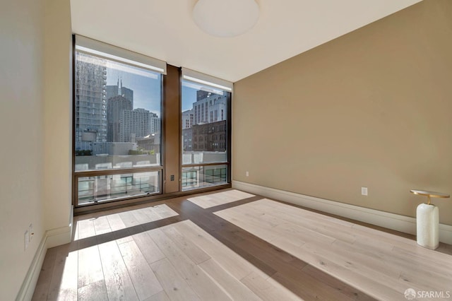 288 Pacific Ave Unit 4E, San Francisco, CA 94111 - spare room with hardwood / wood-style flooring and a city view
