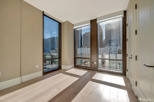 288 Pacific Ave Unit 4E, San Francisco, CA 94111 - spare room featuring floor to ceiling windows and wood-type flooring