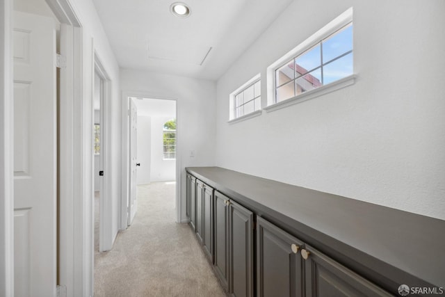 hall featuring light carpet and recessed lighting