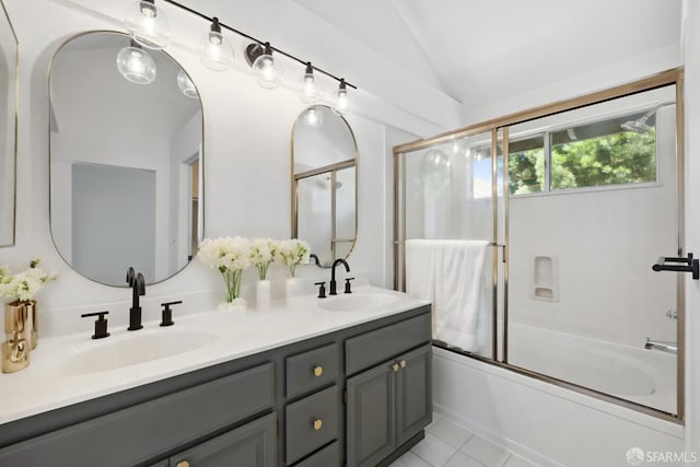 bathroom featuring double vanity, enclosed tub / shower combo, a sink, and lofted ceiling