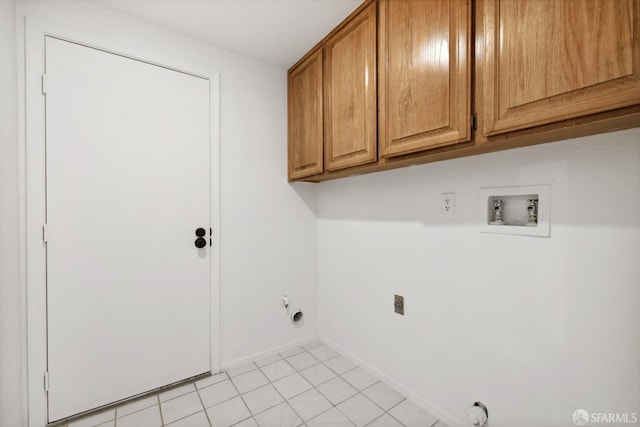 clothes washing area featuring electric dryer hookup, hookup for a gas dryer, cabinet space, baseboards, and hookup for a washing machine
