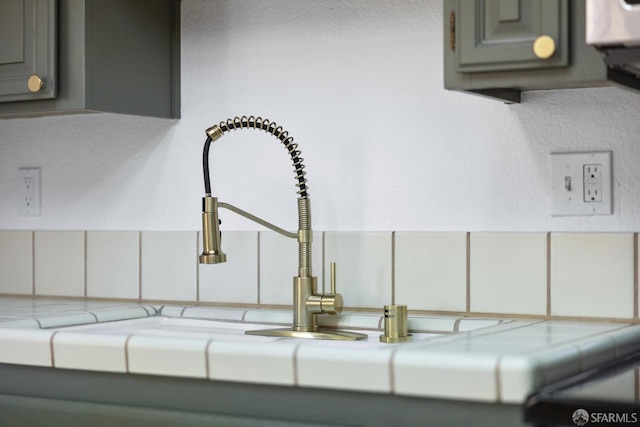 interior details featuring backsplash and gray cabinetry