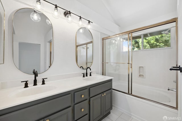 bathroom featuring a sink, enclosed tub / shower combo, double vanity, and lofted ceiling